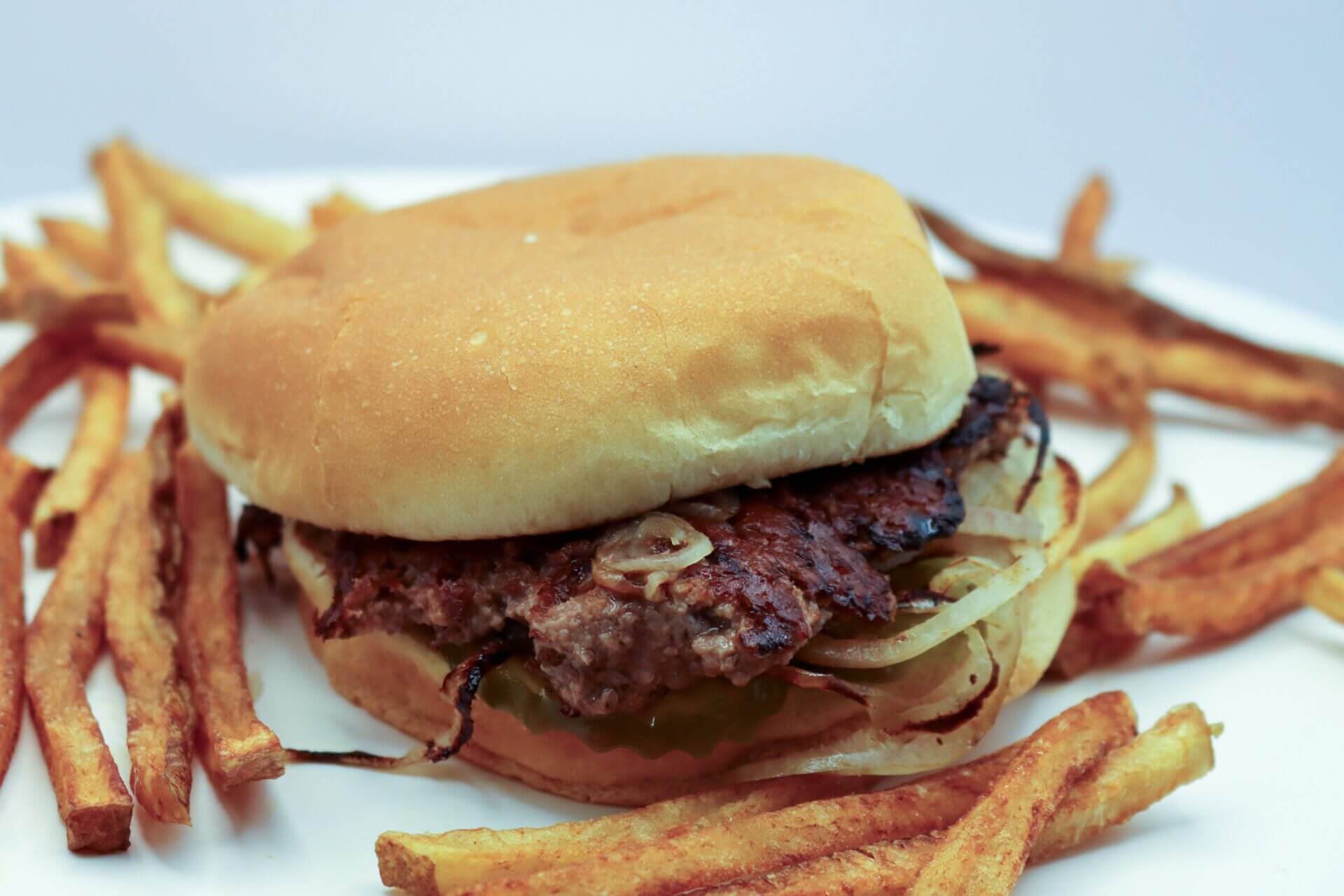 side-view-burger-with-beef-meat-melted-cheese-vegetables-wooden-board